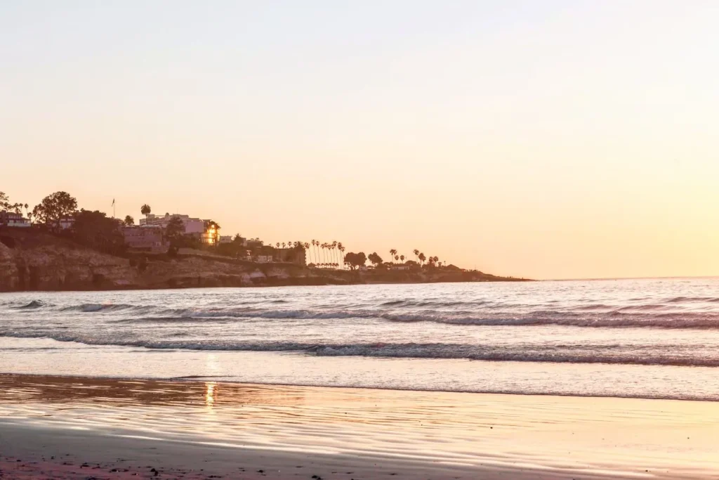 Waves rolling in on the shores of the Pacific Ocean at sunset at La Jolla Beach & Tennis Club